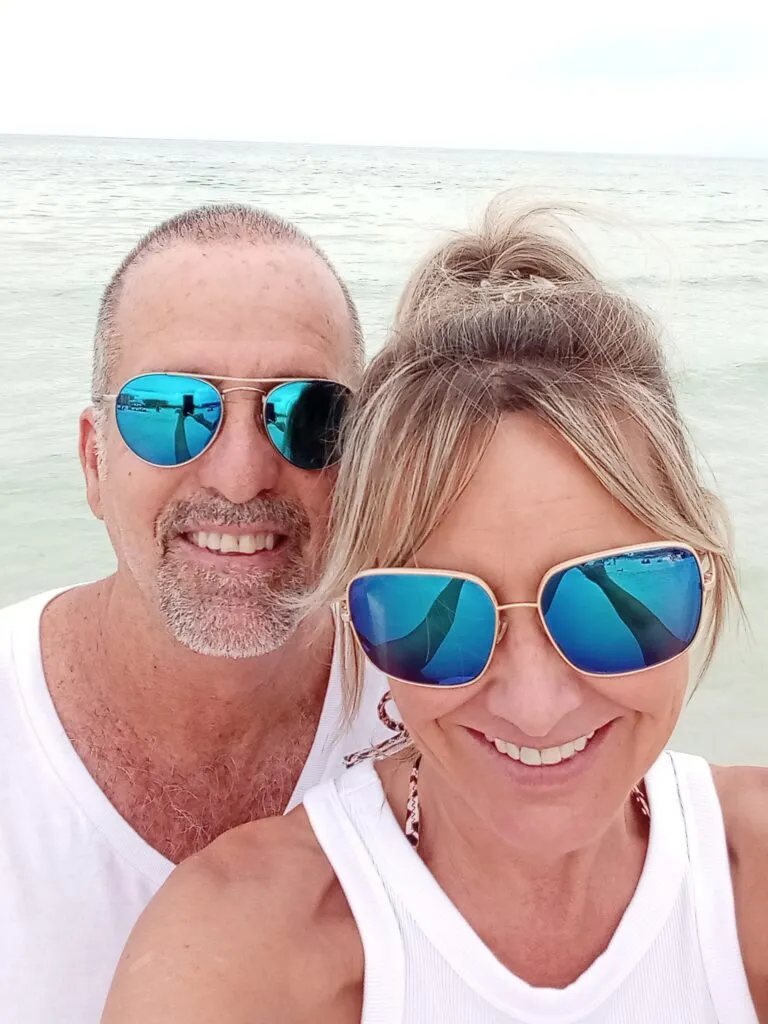 Vince and Tara Fontana, owners of Tager Optical, wearing sunglasses at the beach